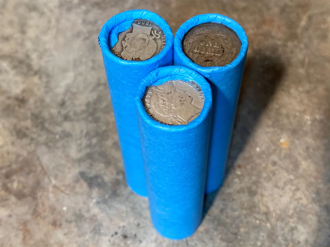 SILVER BARBER DIME showing on end of blue old vintage us wheat cent penny roll