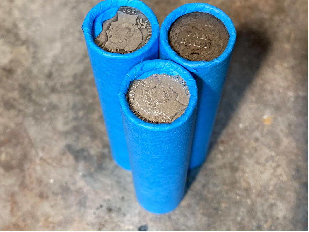 SILVER BARBER DIME showing on end of blue old vintage us wheat cent penny roll