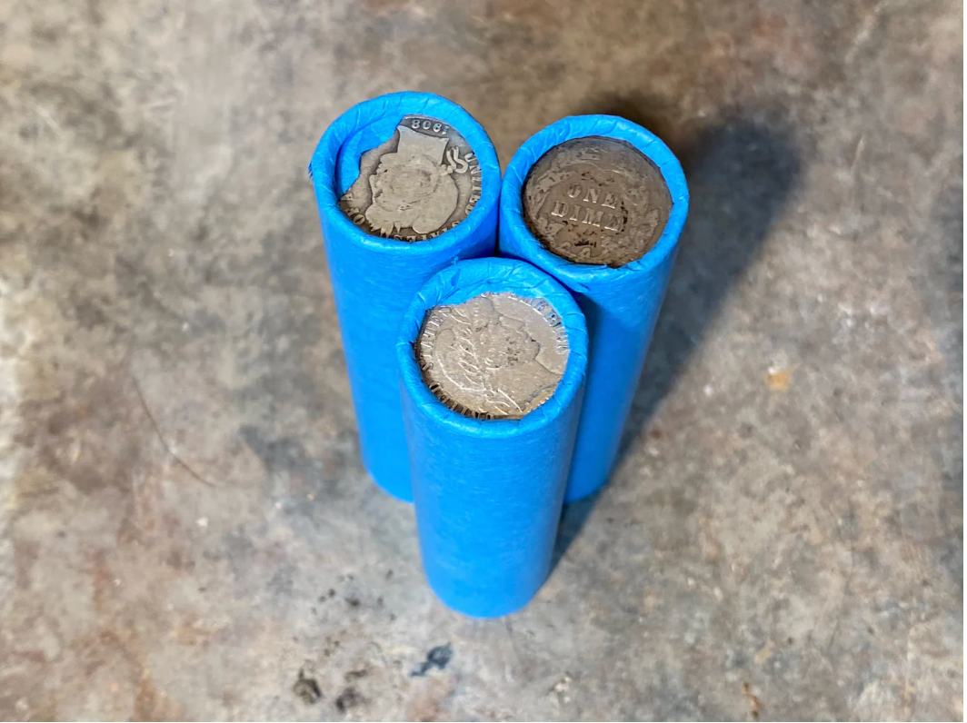 SILVER BARBER DIME showing on end of blue old vintage us wheat cent penny roll