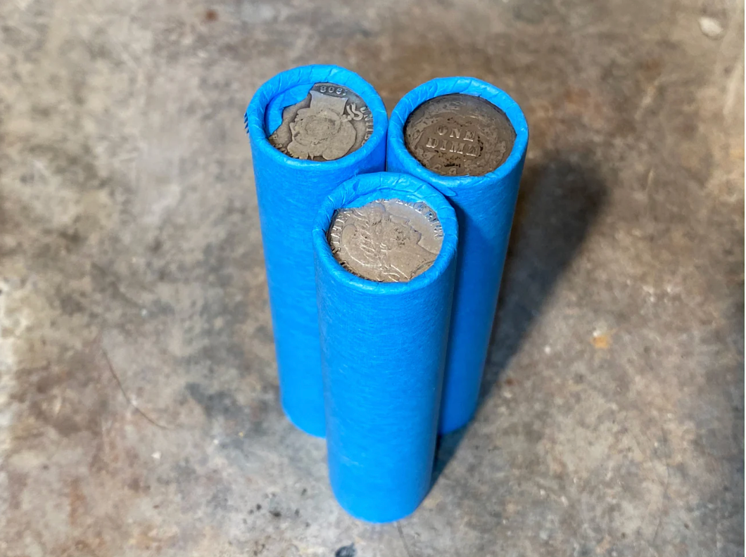 SILVER BARBER DIME showing on end of blue old vintage us wheat cent penny roll