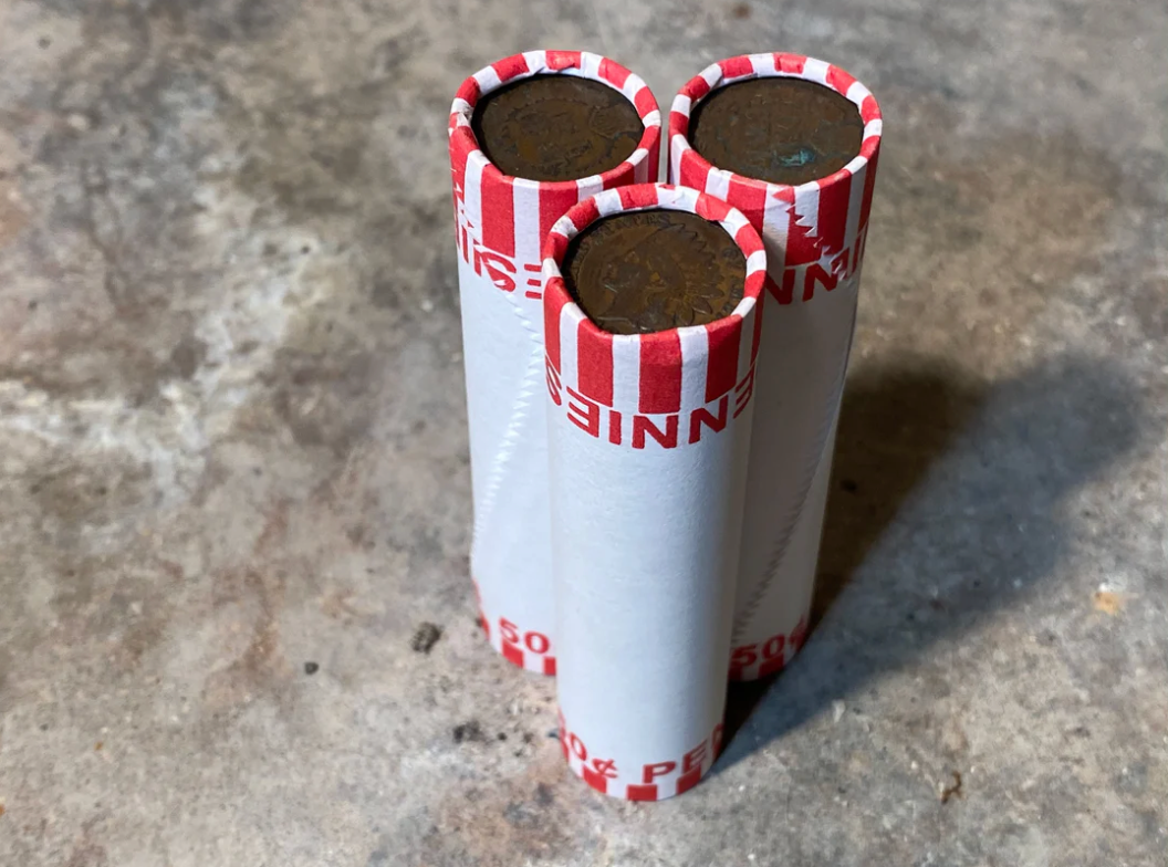 INDIAN HEAD CENT showing on one end of old unsearched white us wheat penny roll