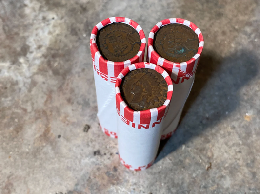 INDIAN HEAD CENT showing on one end of old unsearched white us wheat penny roll