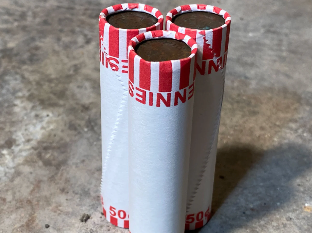 INDIAN HEAD CENT showing on one end of old unsearched white us wheat penny roll